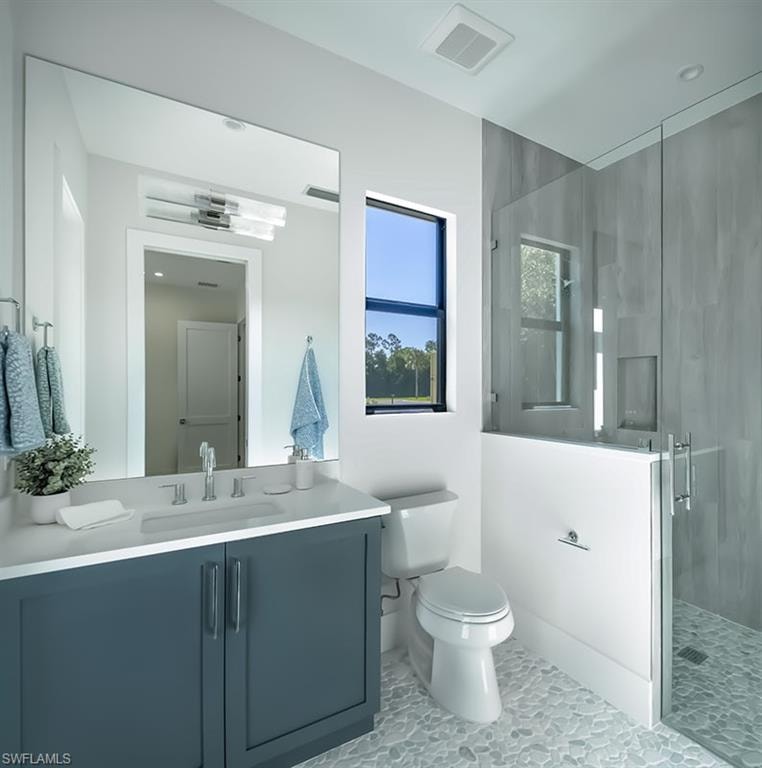 Bathroom with a stall shower, vanity, and light tile patterned floors
