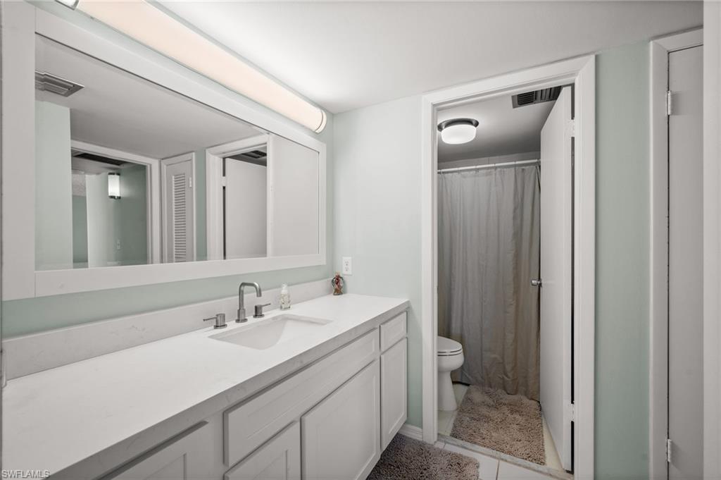 Bathroom with curtained shower