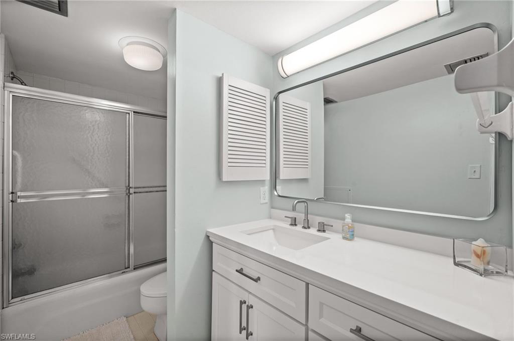 Full bathroom with vanity and shower / bath with glass door