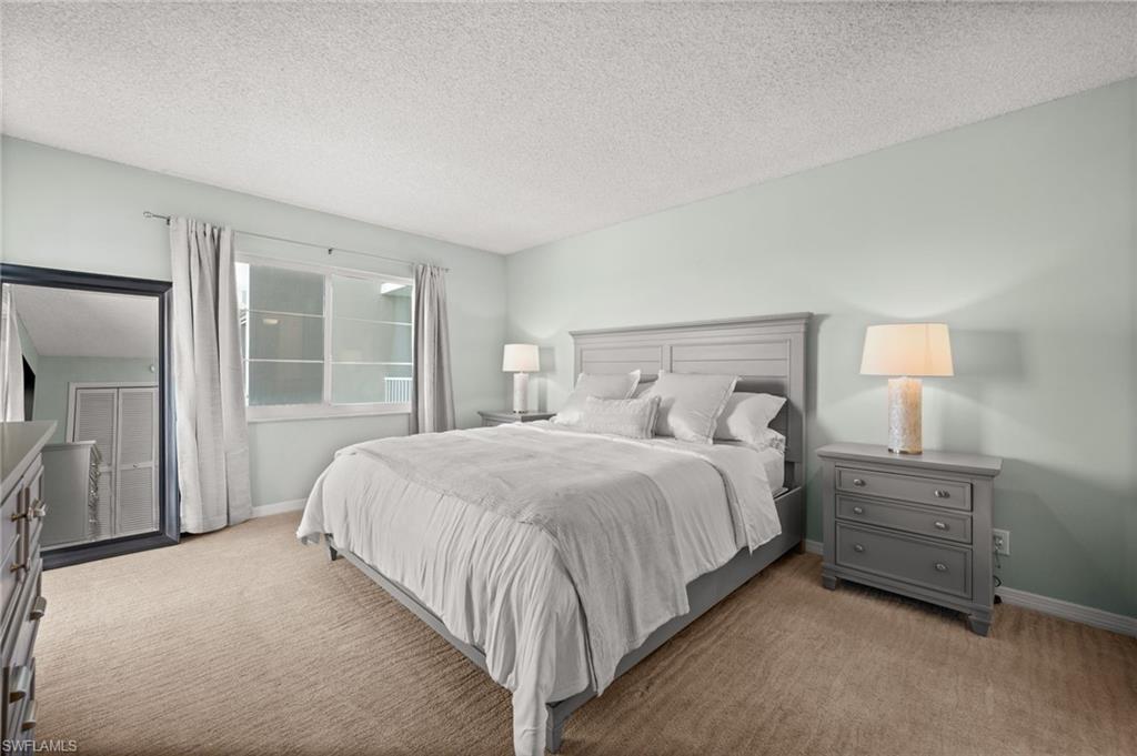 Bedroom featuring a textured ceiling and carpet floors