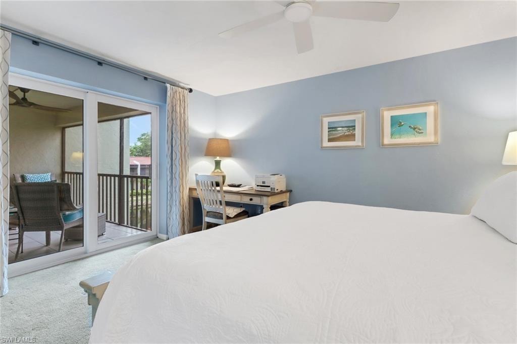 Carpeted bedroom with access to exterior and ceiling fan