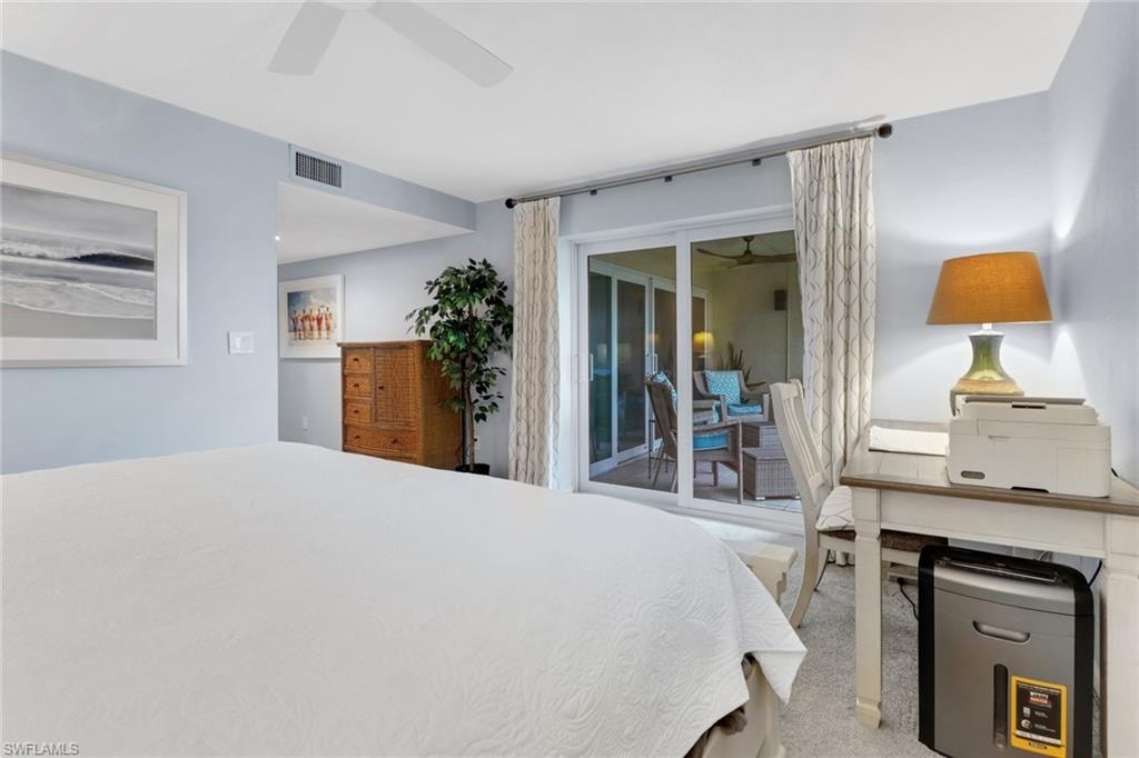 Bedroom featuring access to exterior, light colored carpet, and ceiling fan