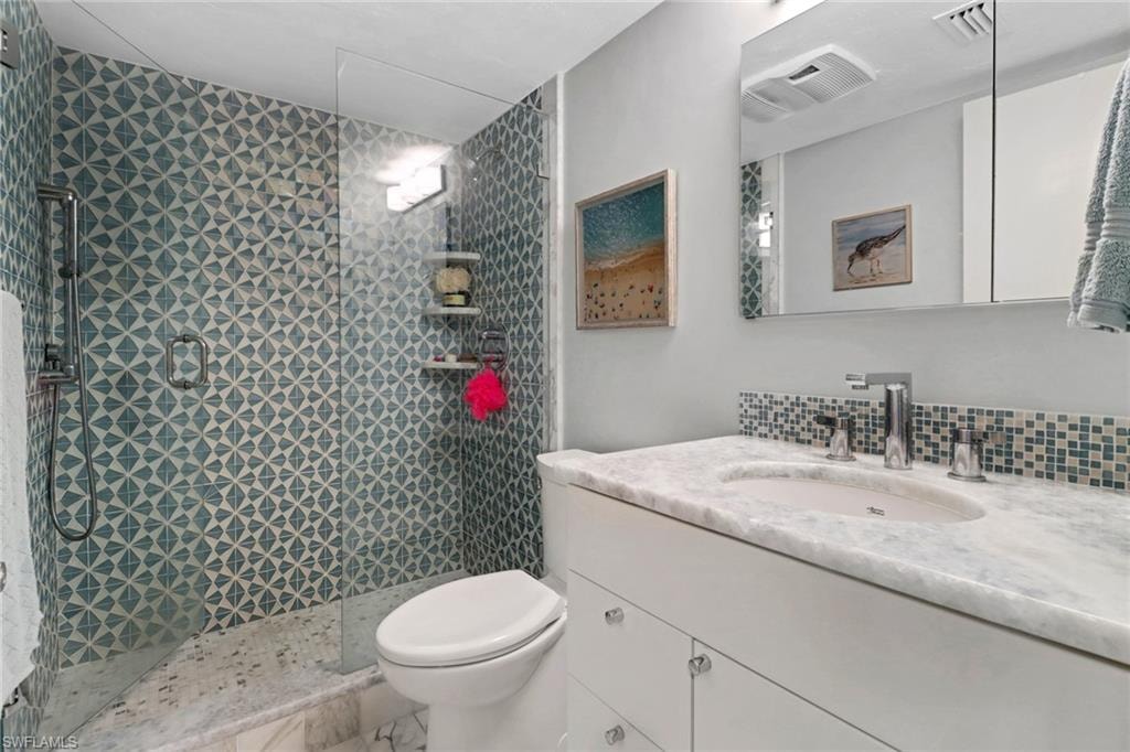 Full bath featuring vanity and a tile shower
