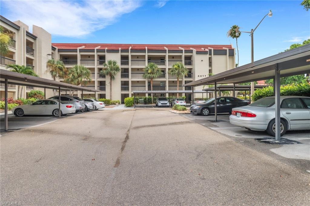 View of property featuring covered parking
