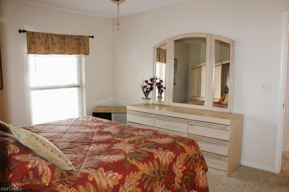 Bedroom featuring carpet flooring and arched walkways