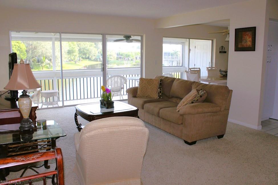 Living room featuring ceiling fan and carpet floors