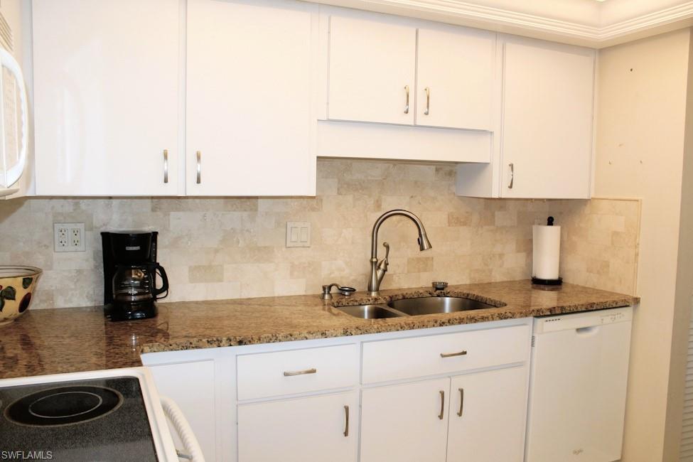 Kitchen with dishwasher, white cabinetry, and stone countertops