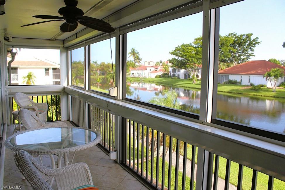 Sunroom featuring ceiling fan and a water view