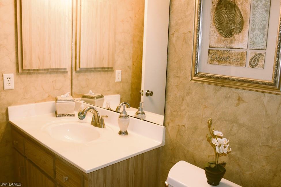 Half bathroom with vanity and toilet