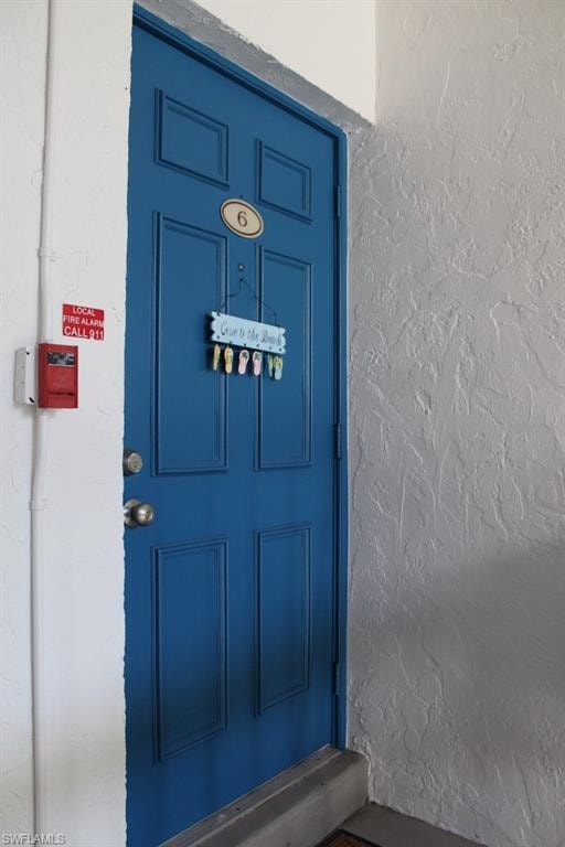 Entrance to property featuring stucco siding