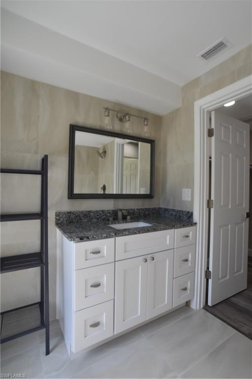 Bathroom with vanity and tile patterned flooring