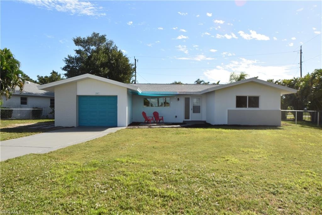 Ranch-style home with a garage, driveway, and stucco siding