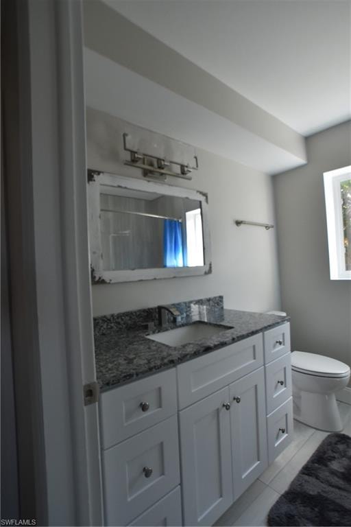 Full bathroom featuring vanity and curtained shower
