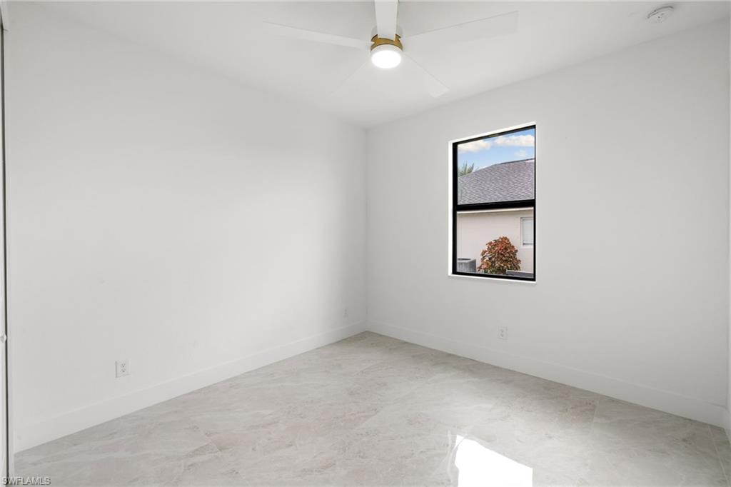 Empty room with a smoke detector and ceiling fan
