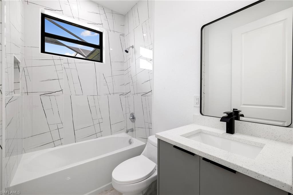 Full bathroom featuring vanity and shower / washtub combination