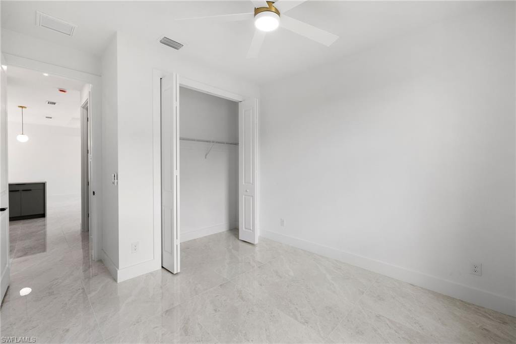 Unfurnished bedroom with a closet and a ceiling fan