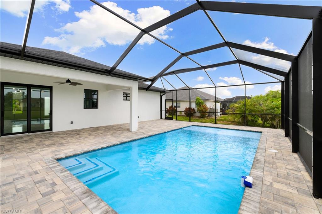 Swimming pool with ceiling fan and a patio area