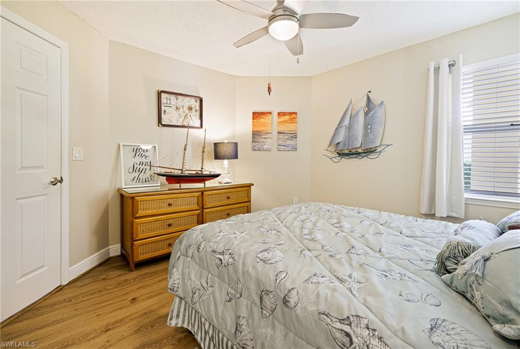 Bedroom with light wood finished floors and a ceiling fan