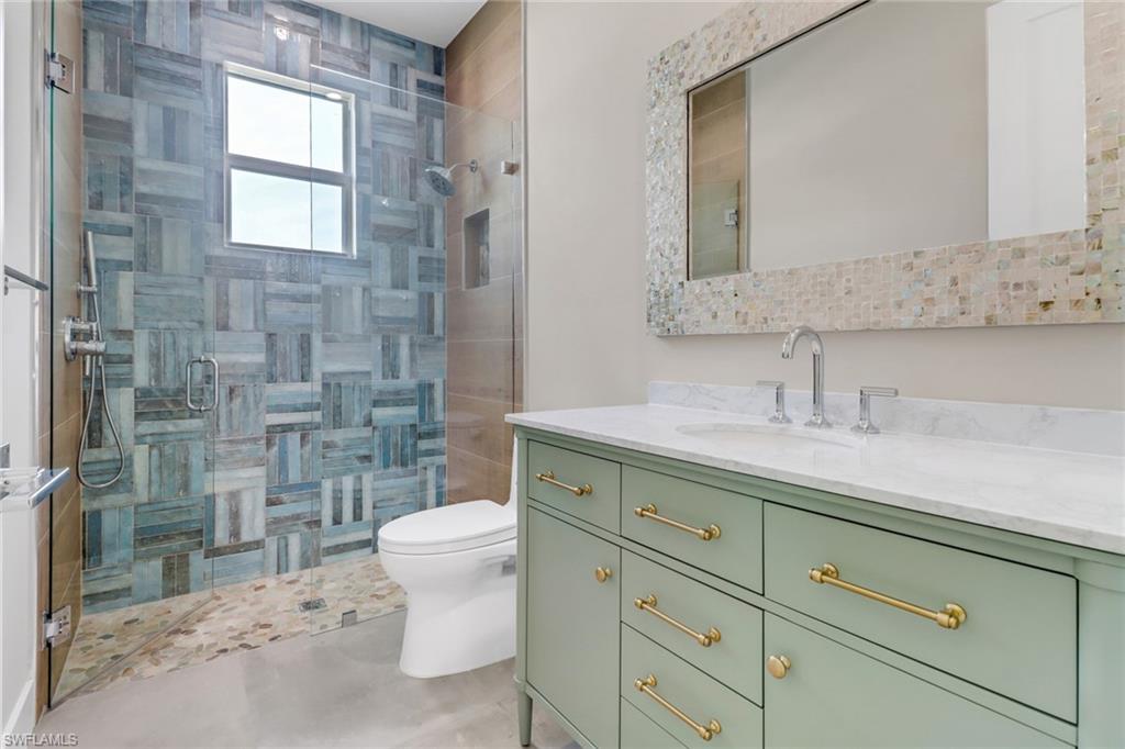 Full bathroom with vanity and a stall shower
