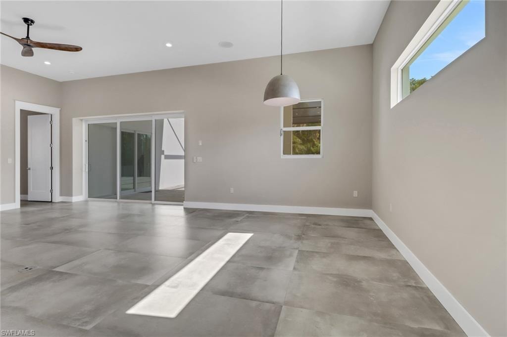 Unfurnished room featuring a ceiling fan, concrete floors, and recessed lighting