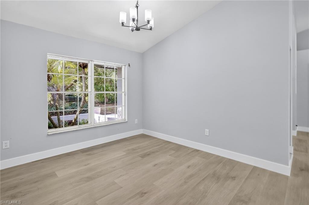 Dining room featuring a chandelier, and vaulted ceiling.