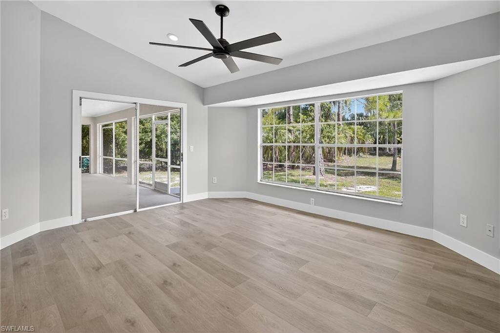 Family room featuring healthy amount of natural light, ceiling fan, and vaulted ceiling.