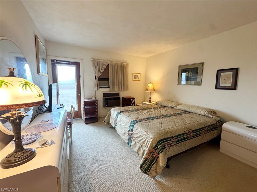 Bedroom featuring carpet flooring and access to outside