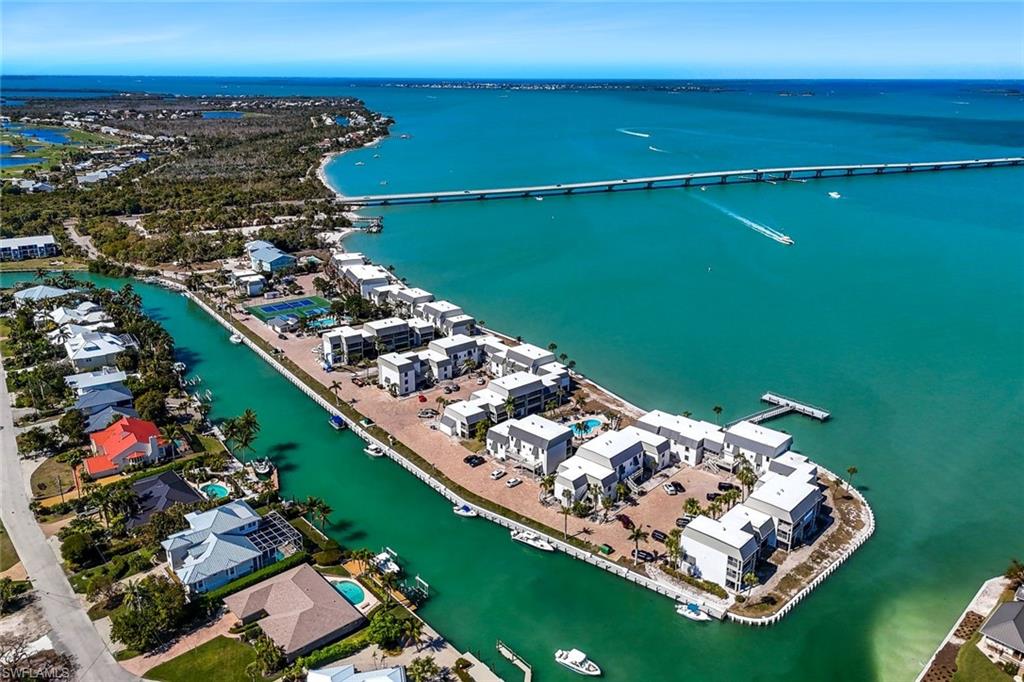 Aerial view of property and surrounding area with a large body of water and a notable bridge