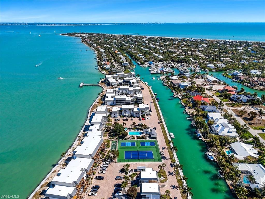 Aerial view of property and surrounding area with a nearby body of water