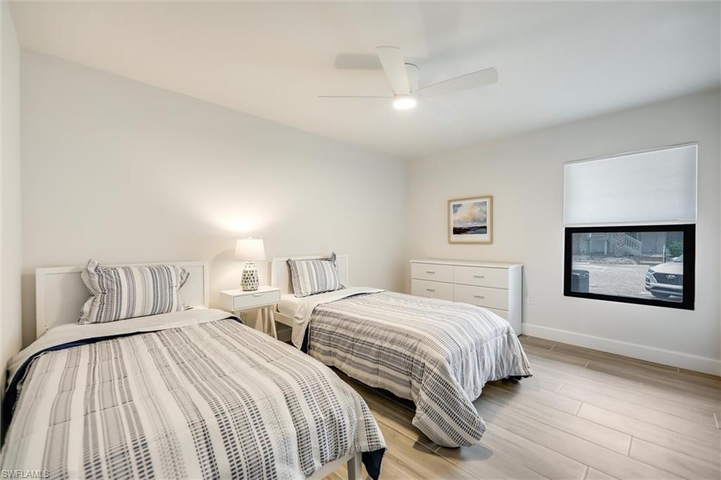 Bedroom with light wood-type flooring and a ceiling fan