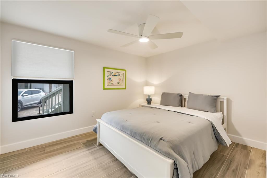 Bedroom with wood finished floors and a ceiling fan