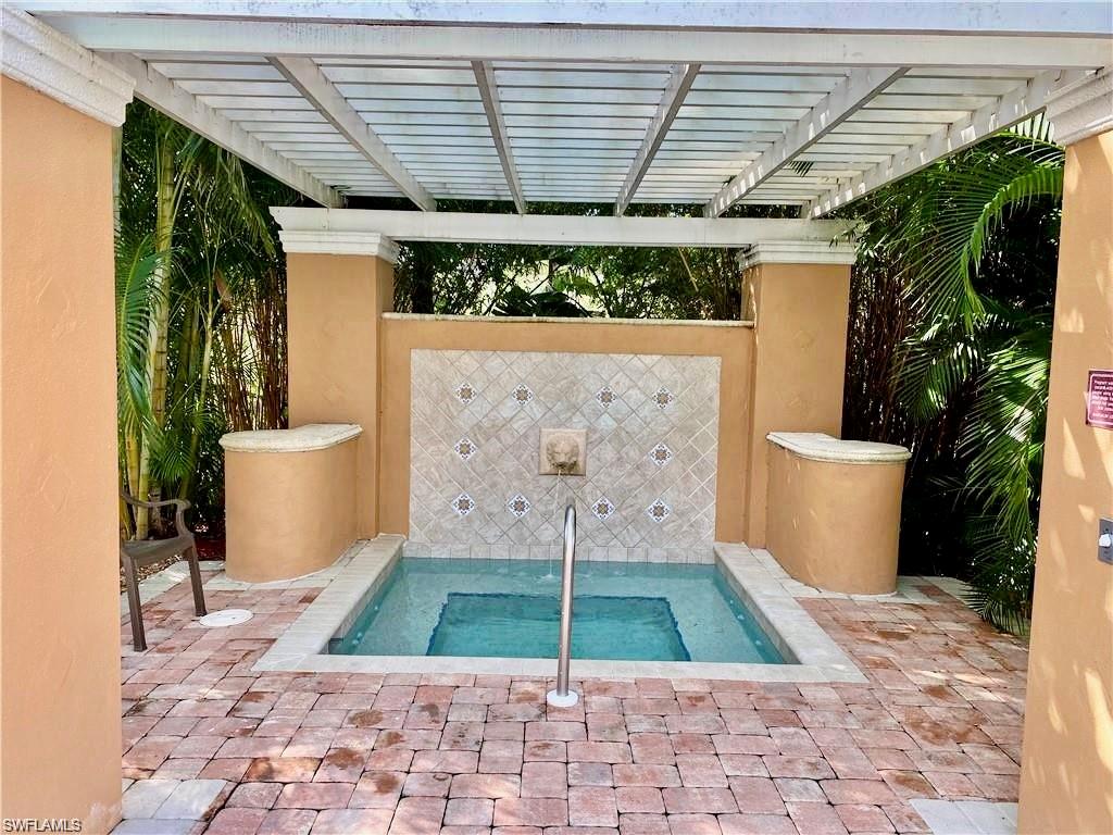 View of pool featuring a hot tub and a swimming pool