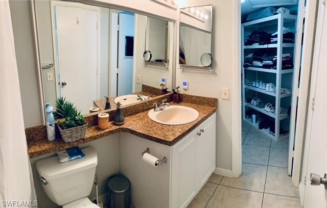 Bathroom with tile patterned floors and vanity