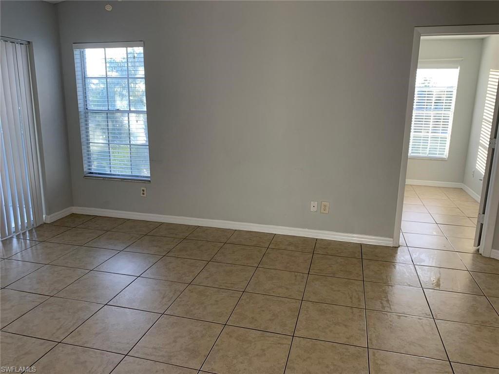Unfurnished room featuring light tile patterned floors and baseboards