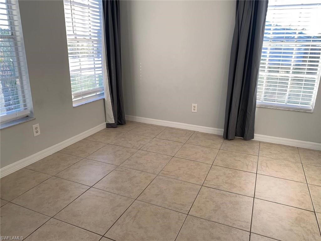 Empty room with light tile patterned floors
