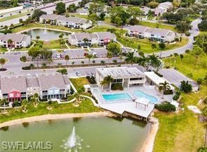 Aerial view of property's location featuring a pool and a large body of water