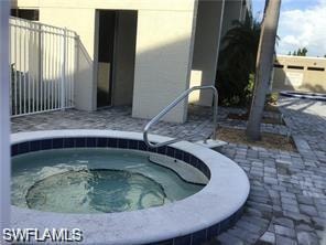 View of swimming pool featuring a community hot tub