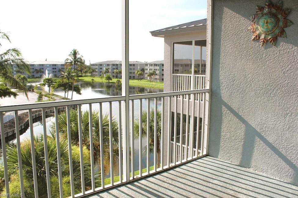 Balcony featuring a water view and a residential view