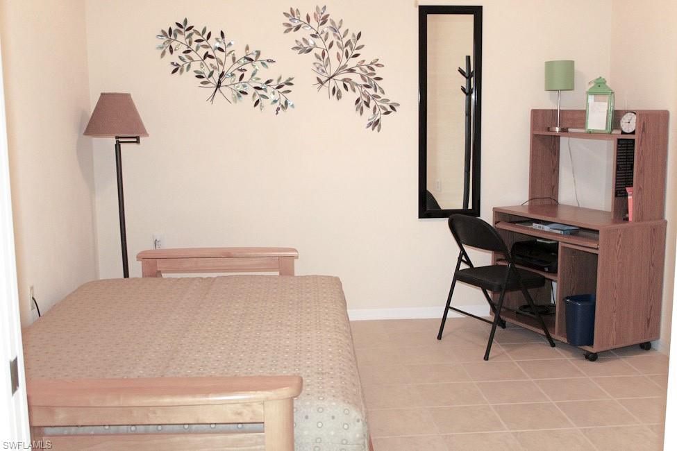 Office area featuring baseboards and light tile patterned floors