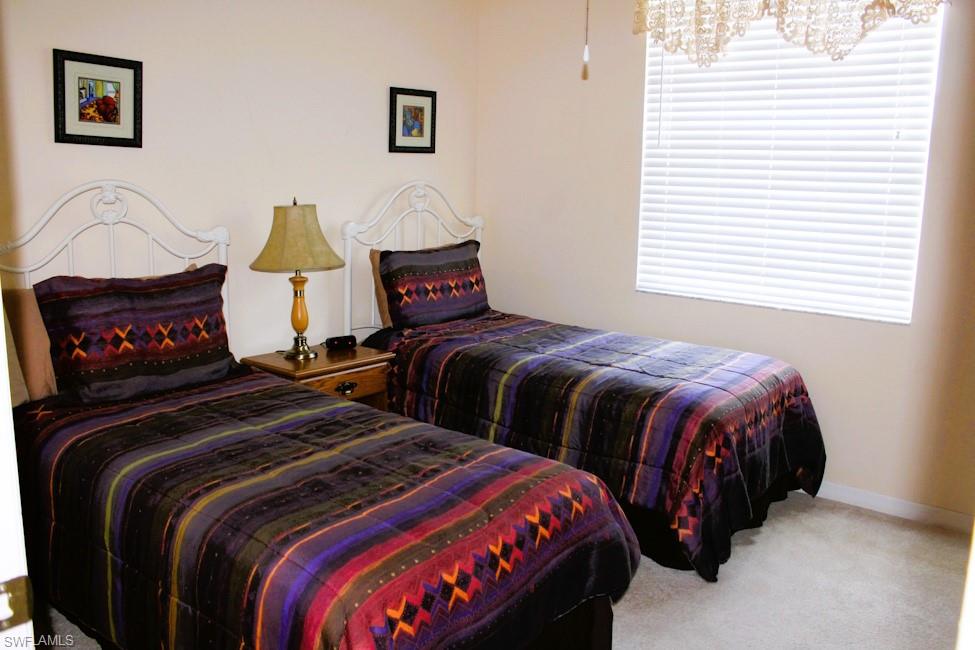 Carpeted bedroom featuring baseboards