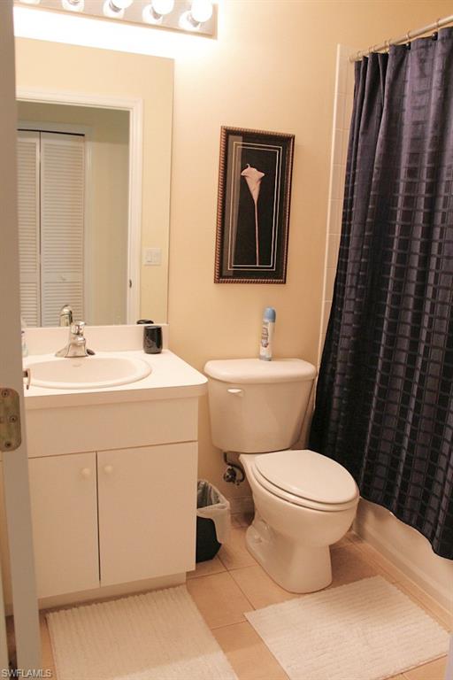 Full bathroom featuring light tile patterned floors, vanity, and shower / tub combo