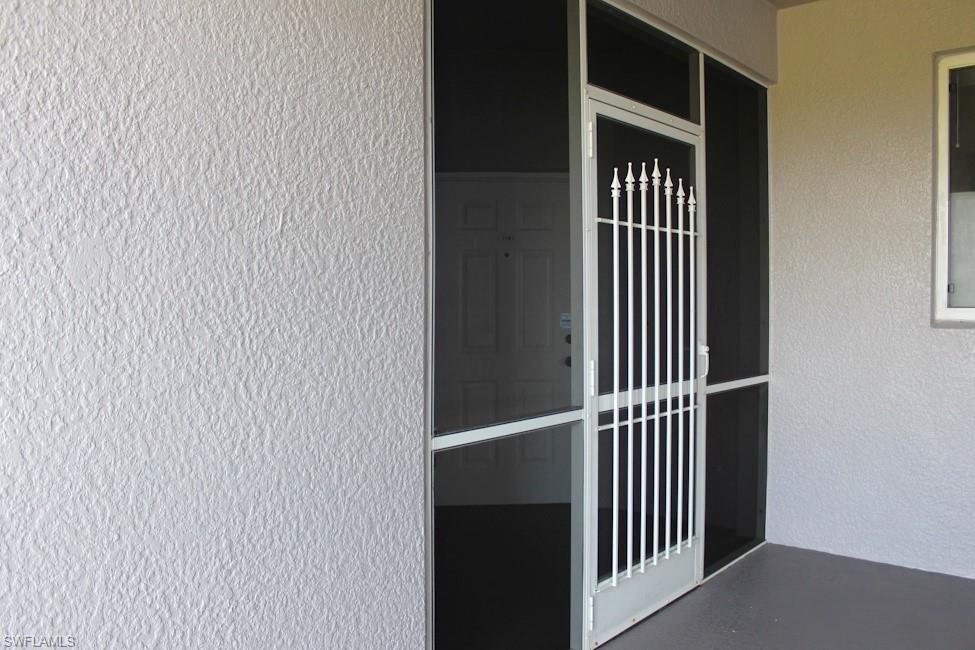 Property entrance with stucco siding