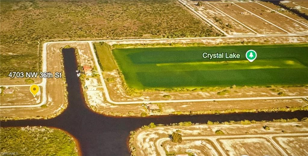 Aerial perspective of suburban area with a large body of water