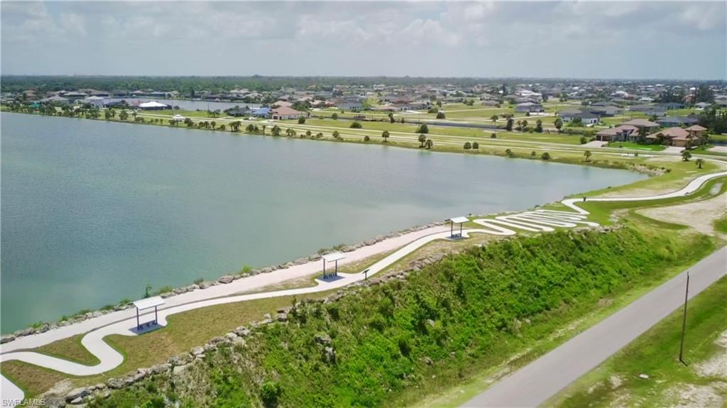 View of property location featuring a large body of water and nearby suburban area