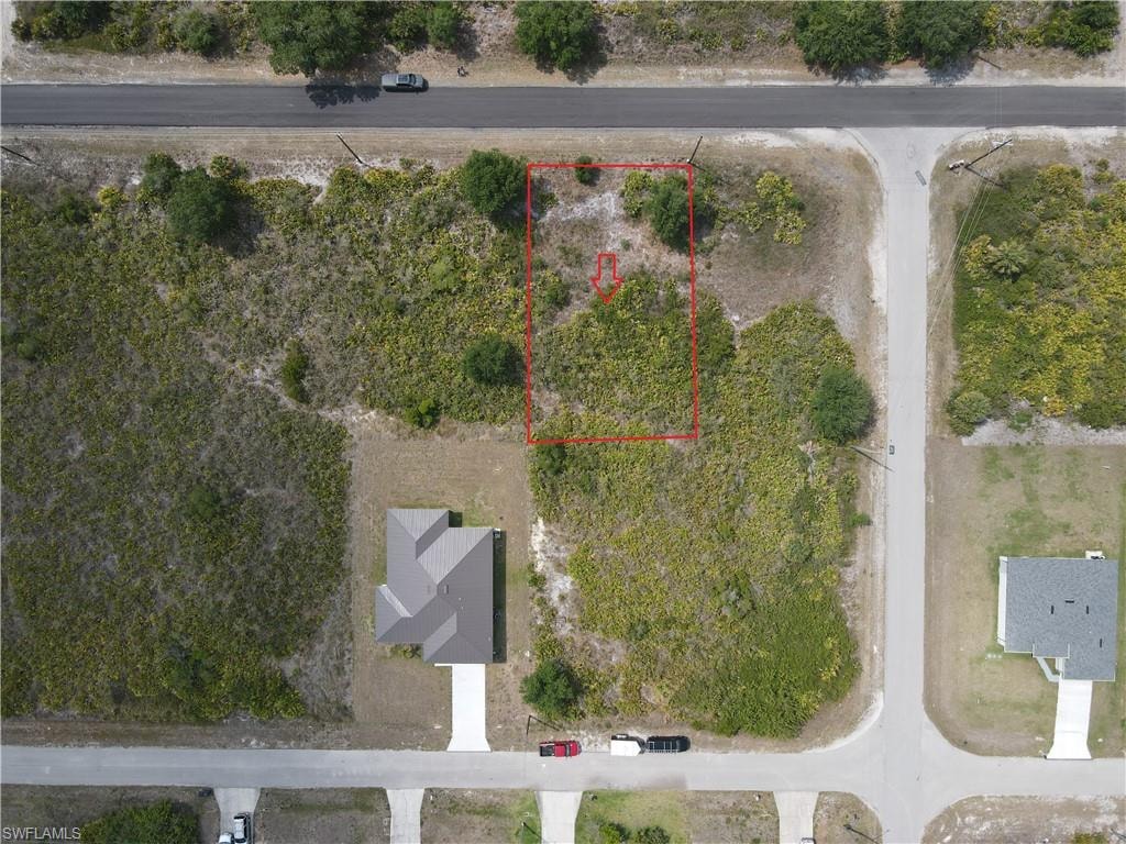 Aerial view of property and surrounding area with property parcel outlined