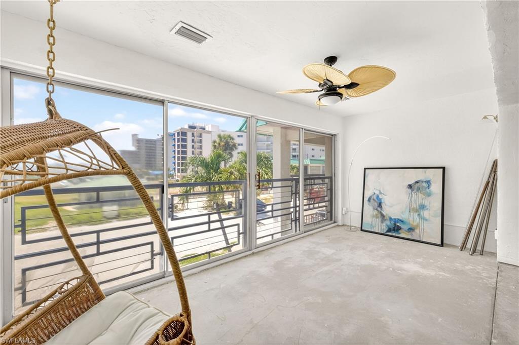 A wall of sliders allow so much Florida sunshine inside.  Your view is of the pool area across the parking lot and the beach to your right. Photo may be digitally enhanced