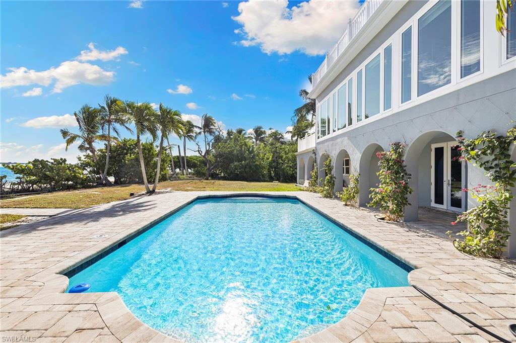 Swimming pool featuring a patio area and a yard