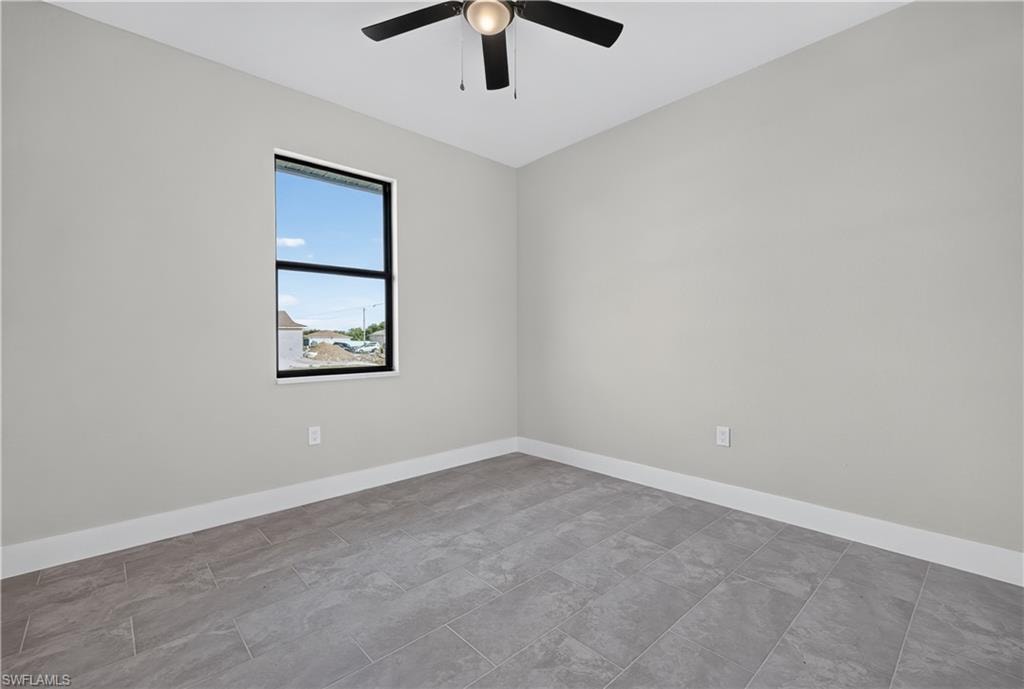 Walk-in closet featuring white wire shelving, light grey painted walls, white baseboards, and neutral-toned tile flooring