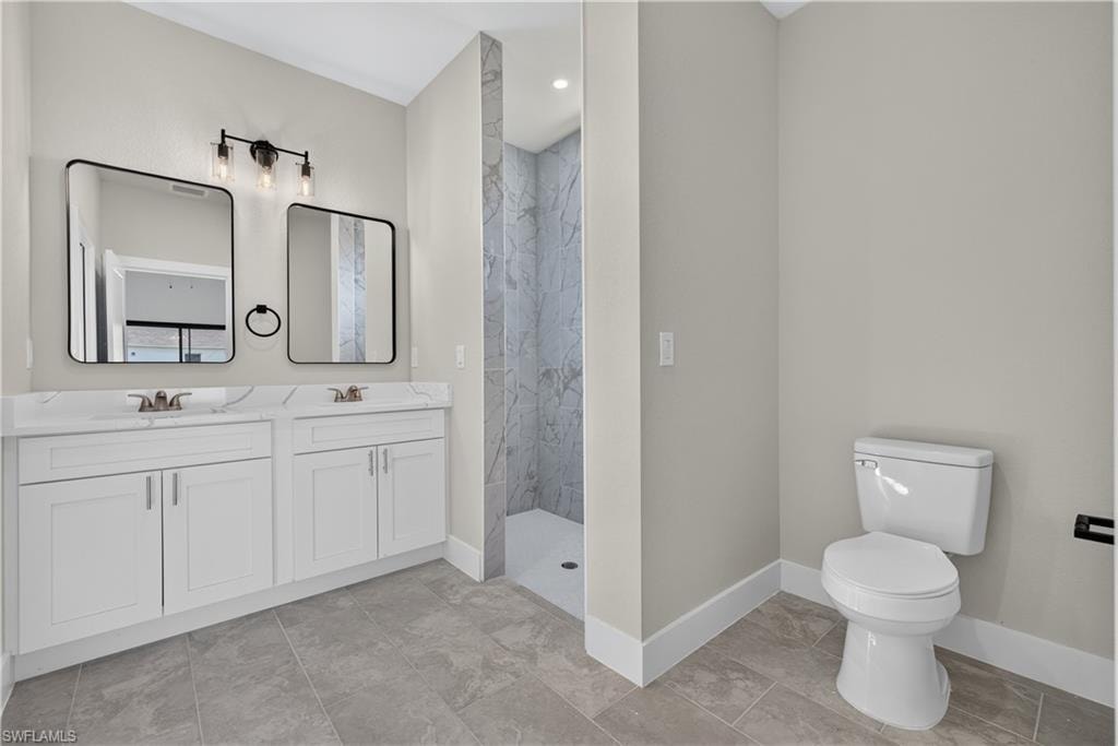 Spacious room featuring neutral-toned walls, contemporary tile flooring, and a ceiling fan