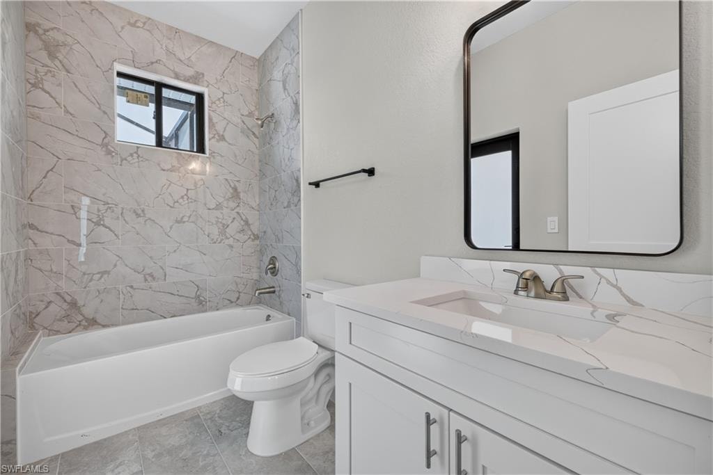 Walk-in shower with large-format marbled tile, a polished chrome shower fixture, and a hexagonal tile floor